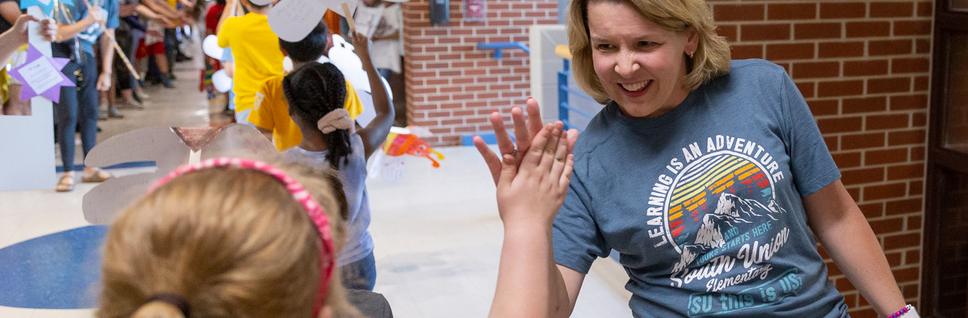 Teacher giving student a high five